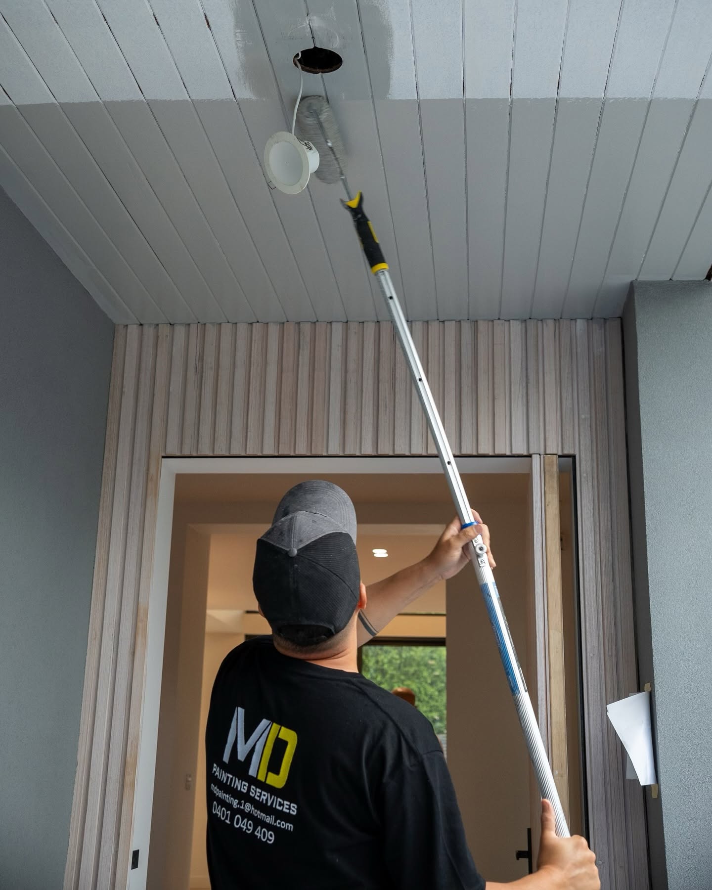 MD Painting Services team member painting a ceiling in Melbourne