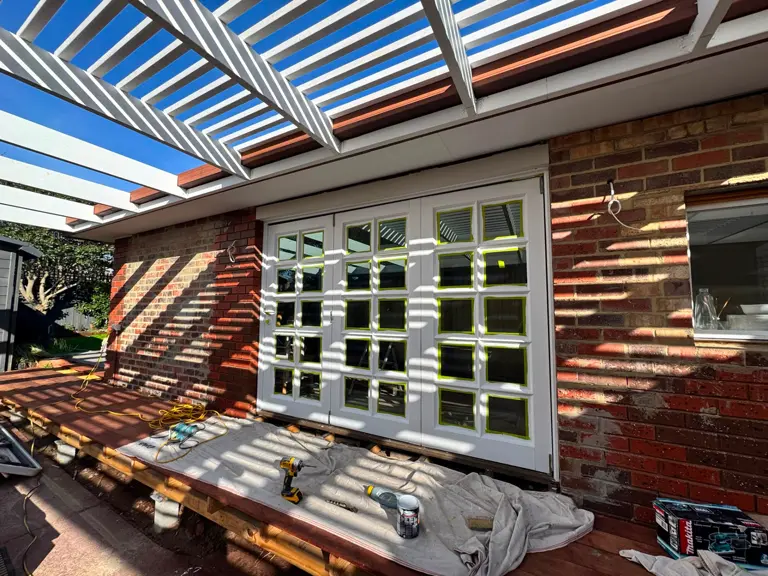 Painted French doors, pergola and brickwork